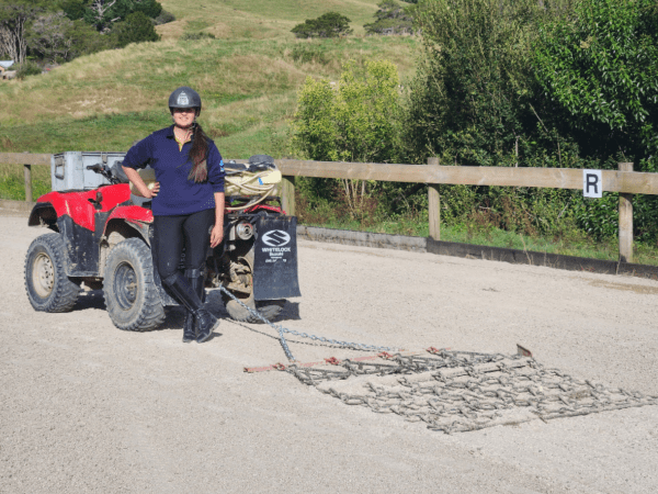 Ella posing with her new arena rake